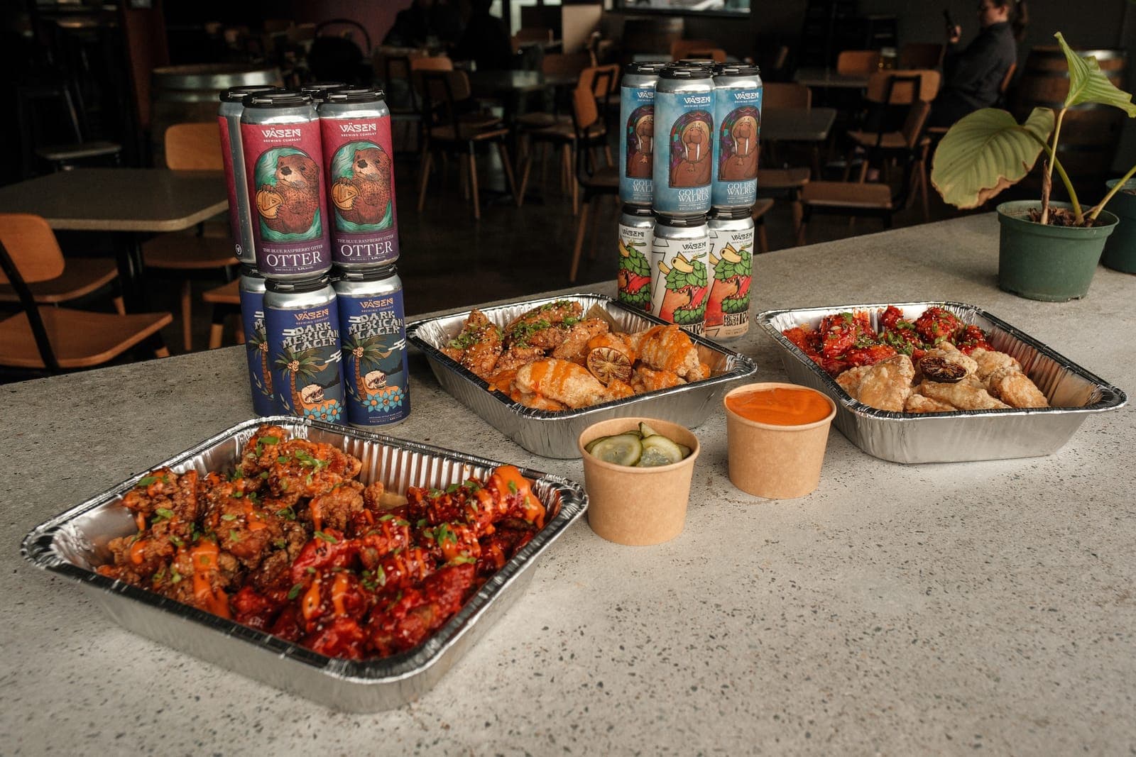 Catering trays from Kobop — wings, tacos, dumplings with Vasen beer